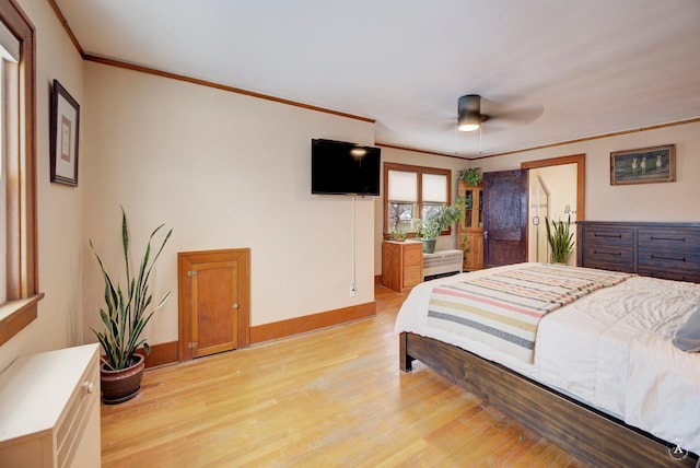 bedroom with ornamental molding, ceiling fan, and light hardwood / wood-style floors