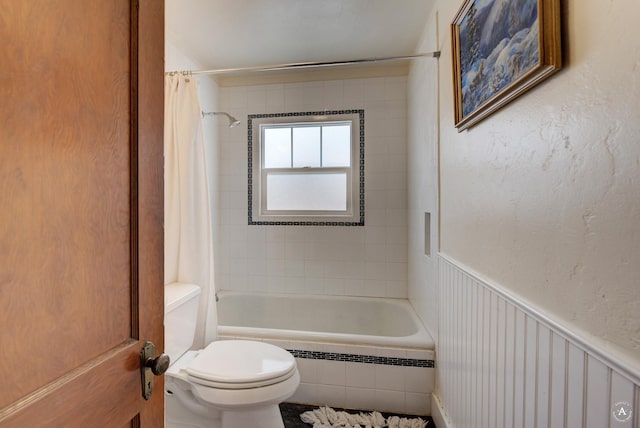 bathroom with shower / tub combo and toilet