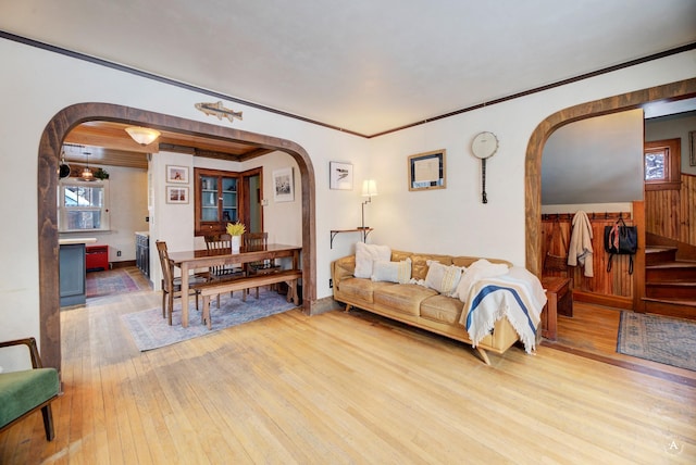 living room with crown molding and light hardwood / wood-style floors