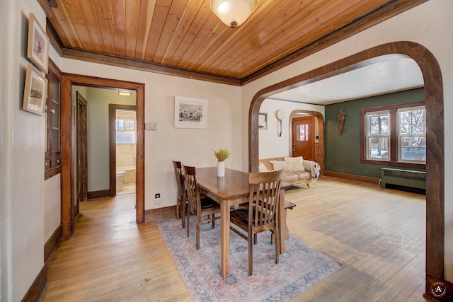 dining area with crown molding, radiator heating unit, wooden ceiling, and light hardwood / wood-style flooring