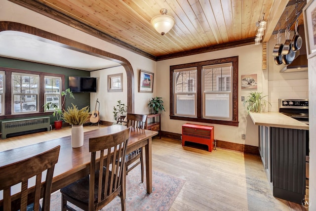 dining room with crown molding, radiator heating unit, wooden ceiling, and light hardwood / wood-style floors