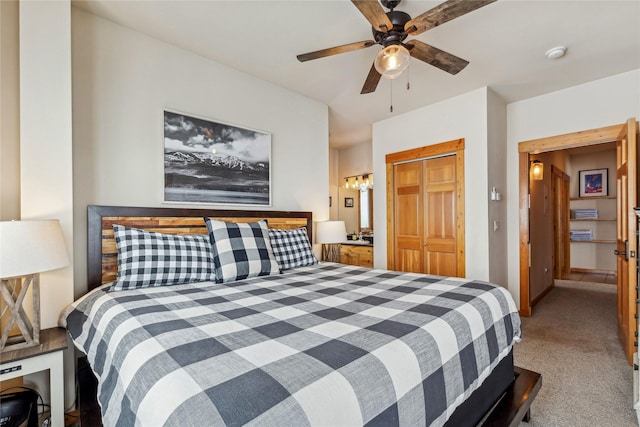 carpeted bedroom featuring ceiling fan and a closet