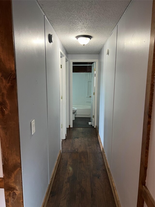 laundry room featuring a textured ceiling, ornamental molding, cabinets, and washing machine and clothes dryer