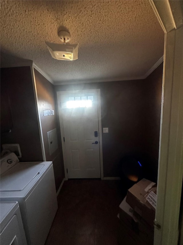 laundry area with washing machine and dryer, ornamental molding, and a textured ceiling