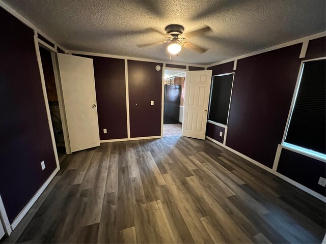 interior space featuring ornamental molding and a textured ceiling