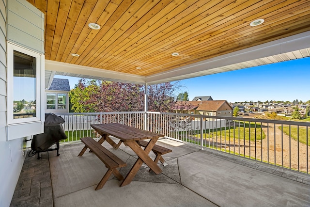 view of patio / terrace featuring grilling area, a balcony, and a residential view