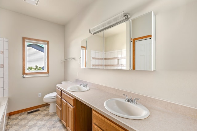 full bathroom featuring toilet, double vanity, visible vents, and a sink