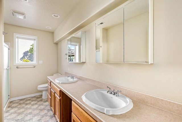 full bath with toilet, visible vents, and a sink