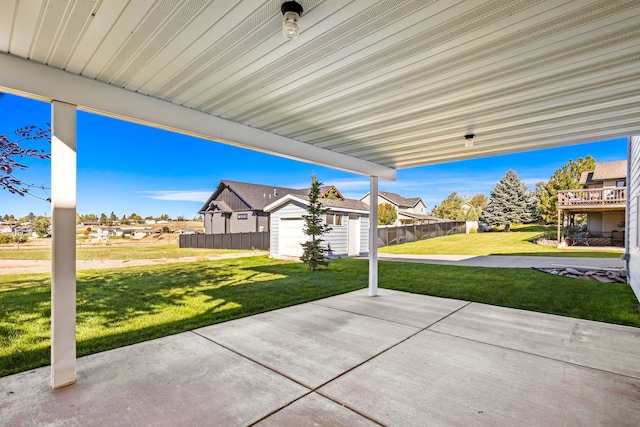 view of patio / terrace featuring fence and an outbuilding