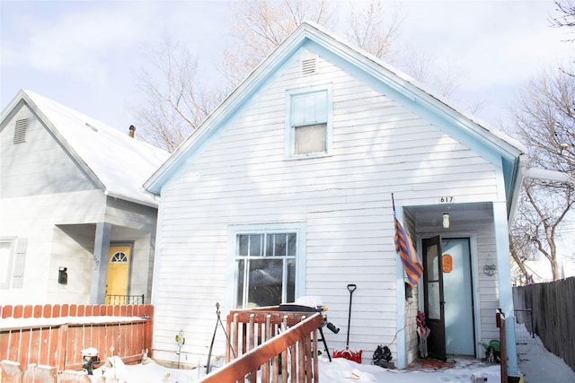 view of snow covered rear of property