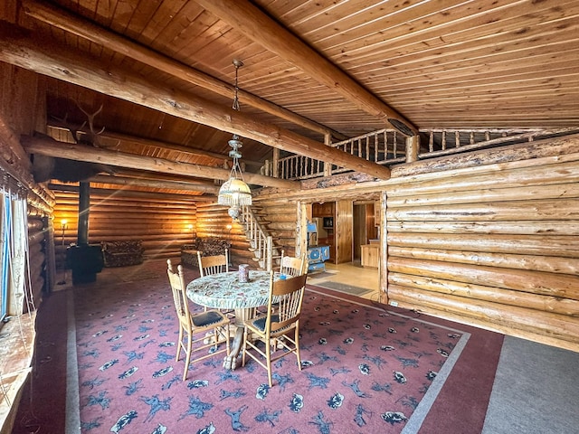 unfurnished dining area with lofted ceiling with beams, carpet, a wood stove, and wooden ceiling