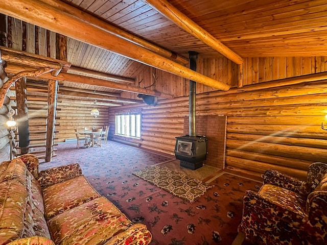 68 River Dr, Cascade, MT 59421 - unfurnished living room featuring a wood stove, wood ceiling with exposed beams, rustic walls, and carpet floors