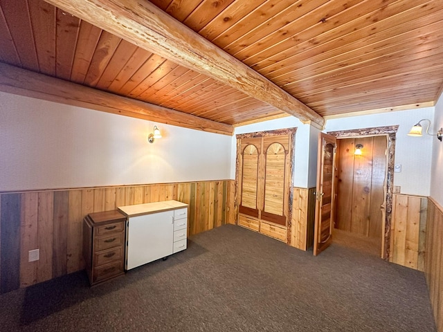 68 River Dr, Cascade, MT 59421 - bonus room with wooden ceiling with exposed beams, a wainscoted wall, wood walls, and dark carpet