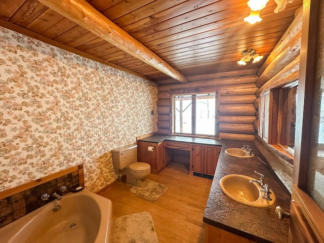 bathroom with hardwood / wood-style flooring, a bathtub, log walls, wooden ceiling, and toilet