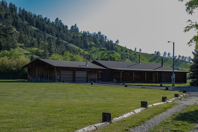 68 River Dr, Cascade, MT 59421 - view of front of house featuring a front lawn, an attached garage, and a mountain view