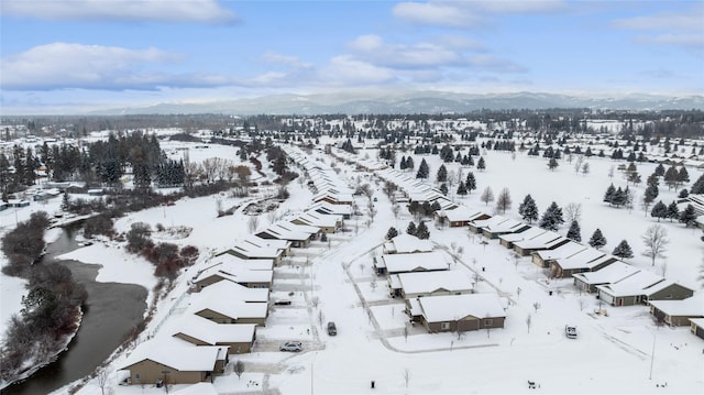 snowy aerial view with a mountain view