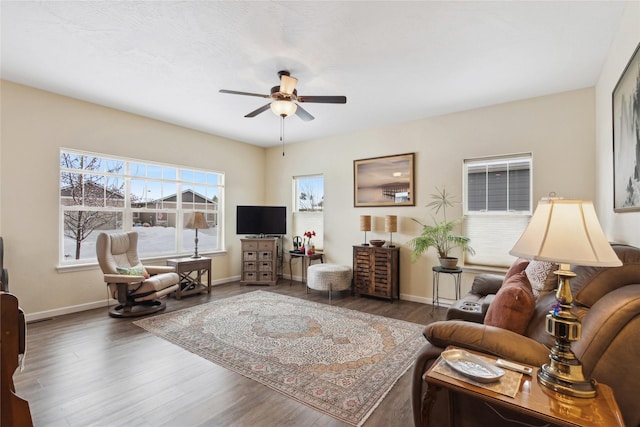 living room featuring ceiling fan and dark hardwood / wood-style floors