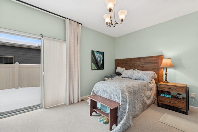 carpeted bedroom featuring an inviting chandelier