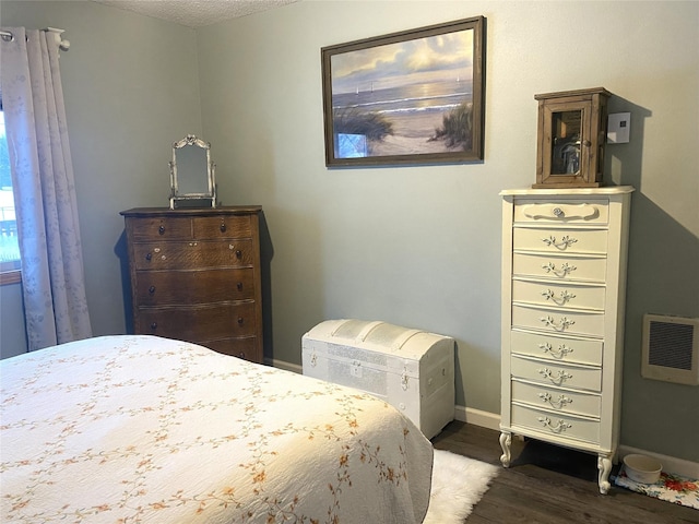 bedroom with dark wood-type flooring