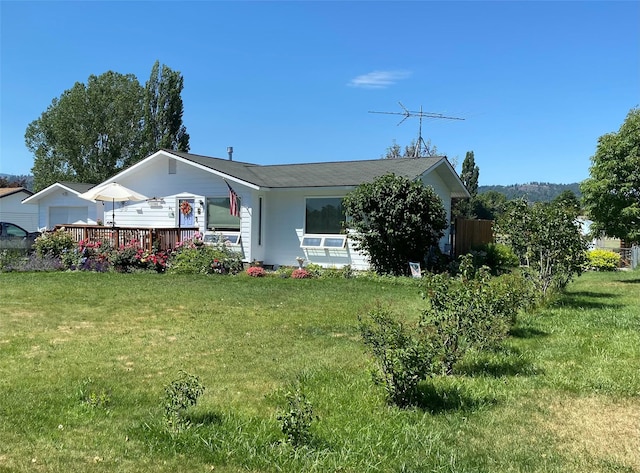 rear view of property featuring a lawn