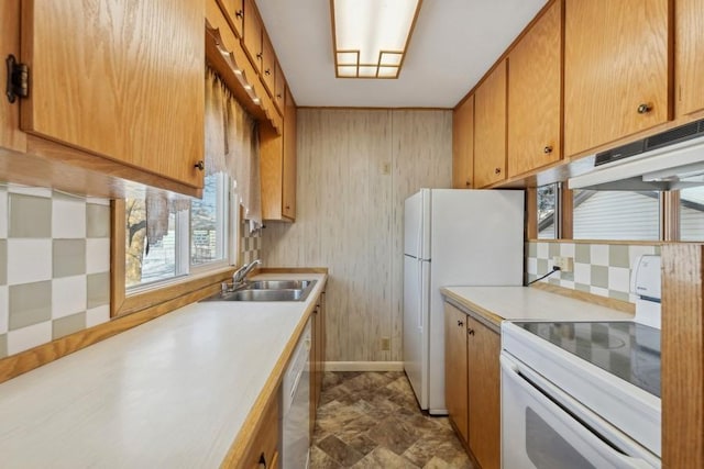185 Veteran Dr, Columbia Falls, MT 59912 - kitchen featuring baseboards, white appliances, light countertops, and a sink