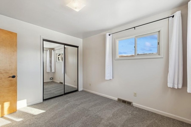 185 Veteran Dr, Columbia Falls, MT 59912 - unfurnished bedroom featuring visible vents, baseboards, a closet, and carpet