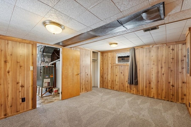 185 Veteran Dr, Columbia Falls, MT 59912 - below grade area with wood walls, heating unit, carpet flooring, and visible vents