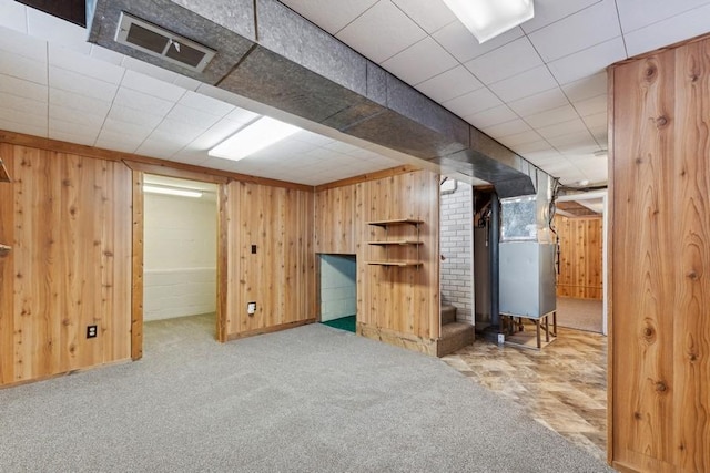 185 Veteran Dr, Columbia Falls, MT 59912 - finished below grade area featuring wooden walls, heating unit, visible vents, and carpet floors