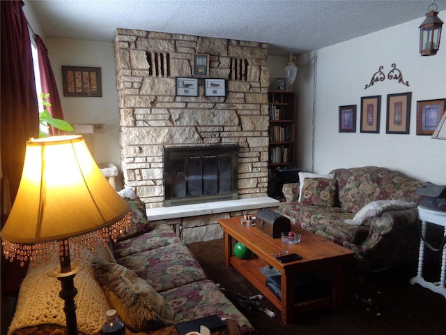 living room featuring a textured ceiling and a fireplace