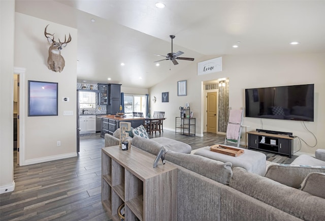 living room featuring dark wood-type flooring, ceiling fan, and vaulted ceiling