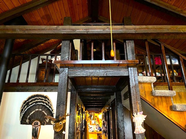 interior space with lofted ceiling with beams and wood walls