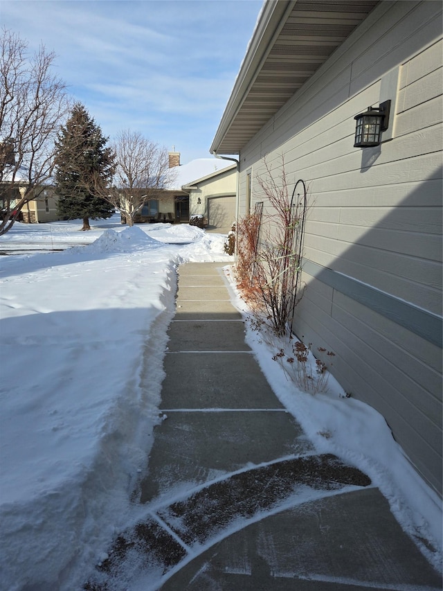 snow covered property featuring a garage