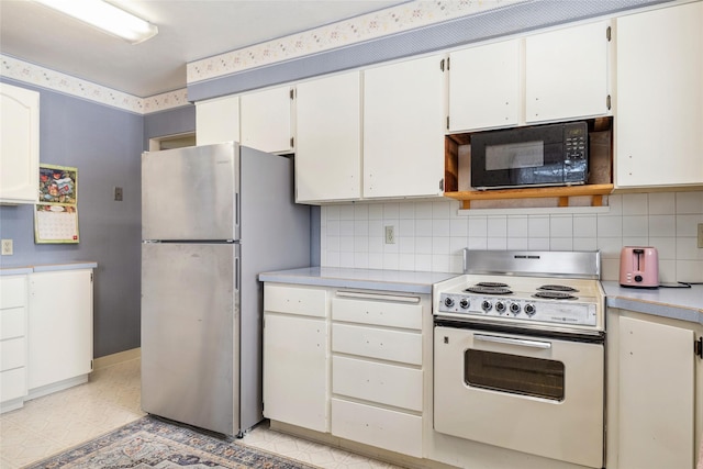 kitchen with stainless steel refrigerator, white cabinets, decorative backsplash, and white range with electric stovetop