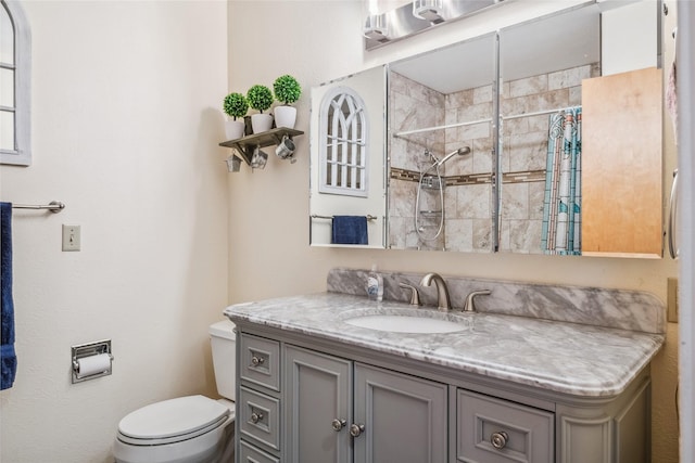 bathroom with a shower with curtain, vanity, and toilet