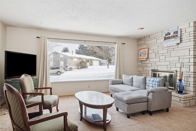 carpeted living room featuring a fireplace and a textured ceiling