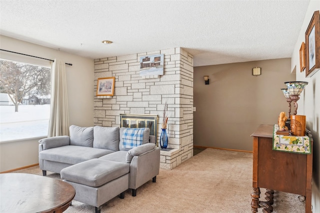 carpeted living room with a stone fireplace and a textured ceiling