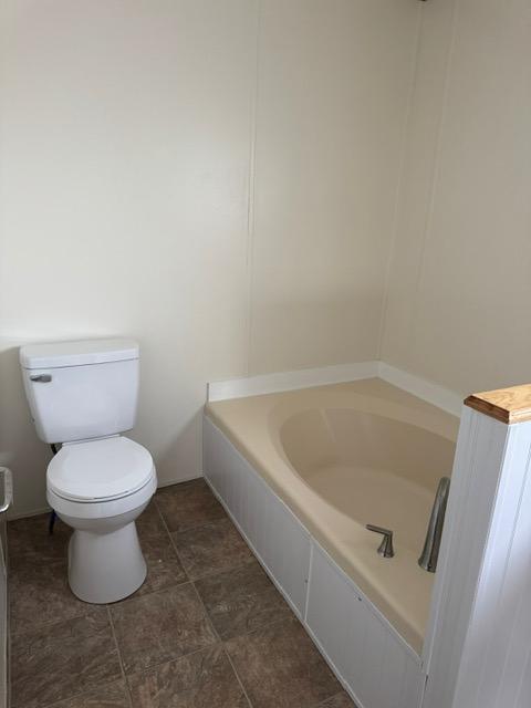 1730 N Hannaford St, Helena, MT 59601 - full bathroom featuring toilet, tile patterned floors, and a tub