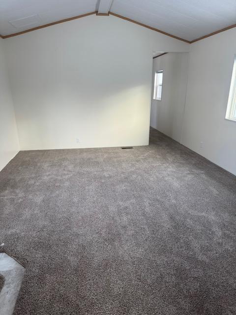 1730 N Hannaford St, Helena, MT 59601 - carpeted spare room with ornamental molding and vaulted ceiling