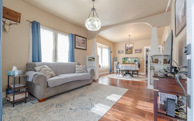 living room featuring wood-type flooring and a chandelier