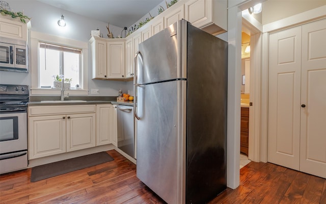 kitchen featuring white cabinetry, sink, dark wood-type flooring, and stainless steel appliances