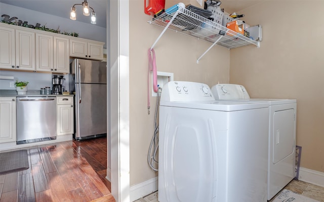 laundry room featuring hardwood / wood-style floors and washing machine and clothes dryer