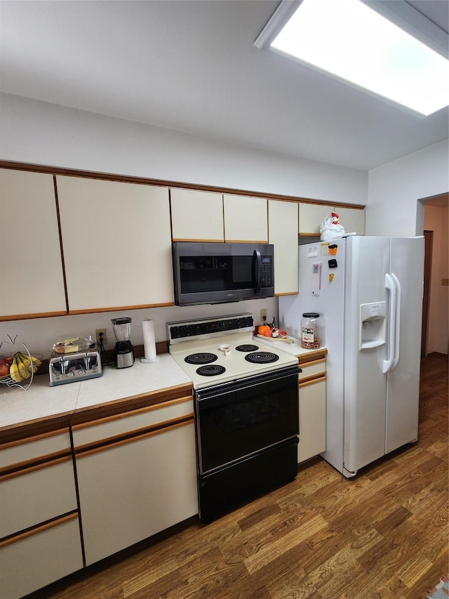 116 29th Ave NE, Great Falls, MT 59404 - kitchen with range with electric cooktop, white fridge with ice dispenser, light countertops, white cabinetry, and wood finished floors