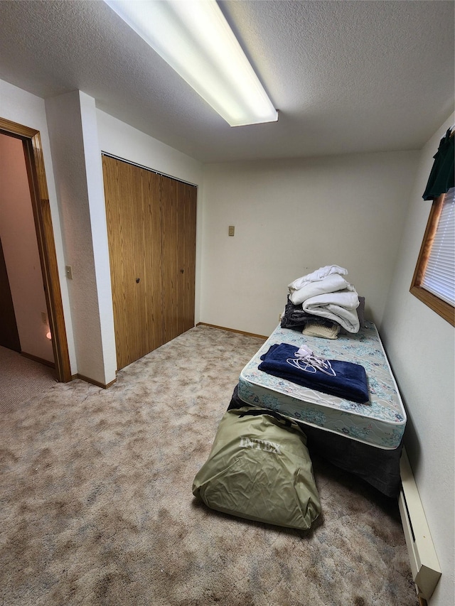 116 29th Ave NE, Great Falls, MT 59404 - carpeted bedroom featuring a baseboard radiator and a textured ceiling