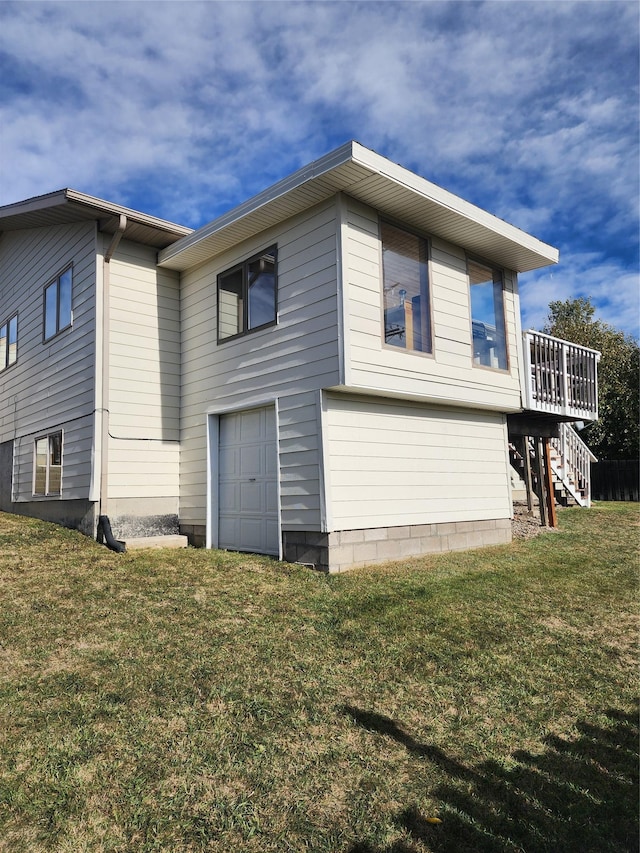 116 29th Ave NE, Great Falls, MT 59404 - back of property with stairs, a yard, a wooden deck, and a garage