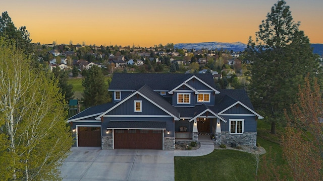 craftsman-style house featuring a porch, a mountain view, and a lawn