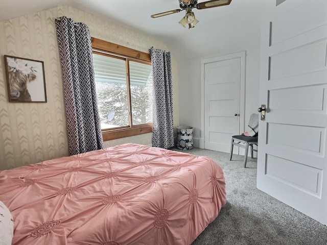 bedroom with vaulted ceiling, light colored carpet, and ceiling fan