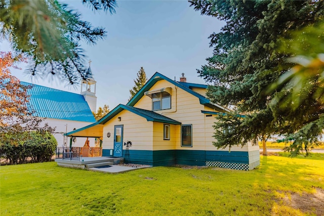 rear view of property featuring a yard