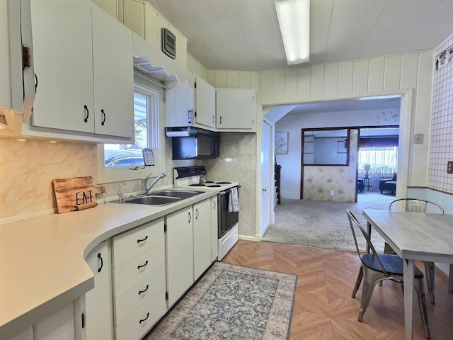 kitchen featuring white cabinetry, light parquet flooring, sink, and white range with electric cooktop