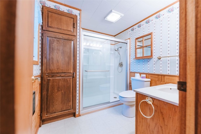 bathroom with crown molding, vanity, toilet, and an enclosed shower