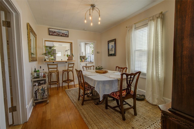 dining area with a wealth of natural light and light wood-type flooring
